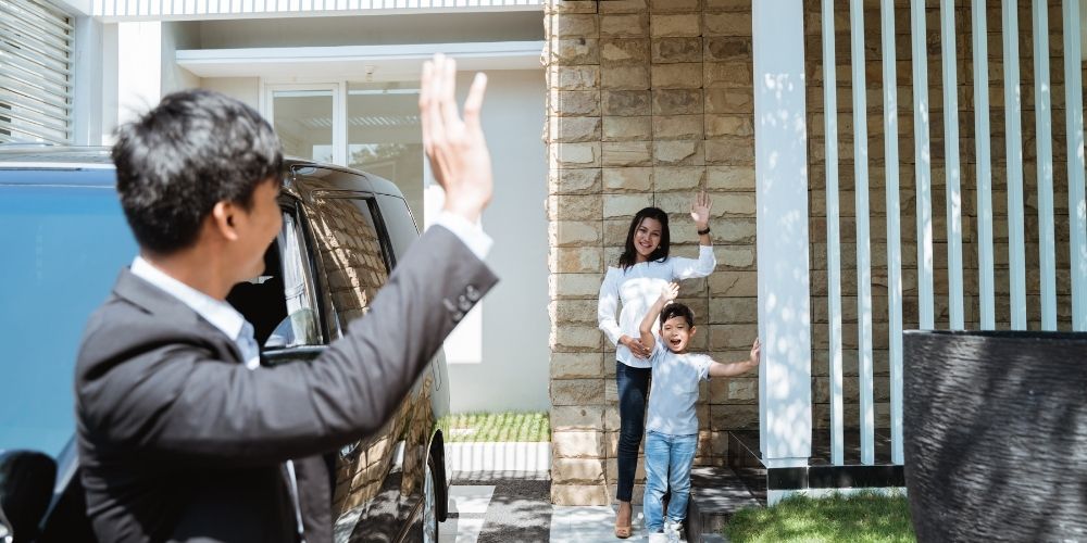 Dad waving to his family as he heads off to work.